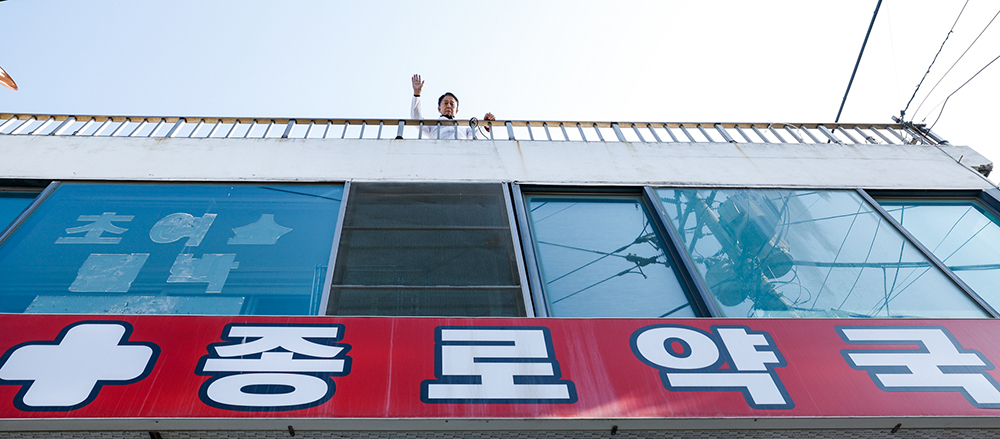 최영덕 약사가 12일 인천 옹진군 백령도 종로약국 옥상에서 손을 흔들고 있다.