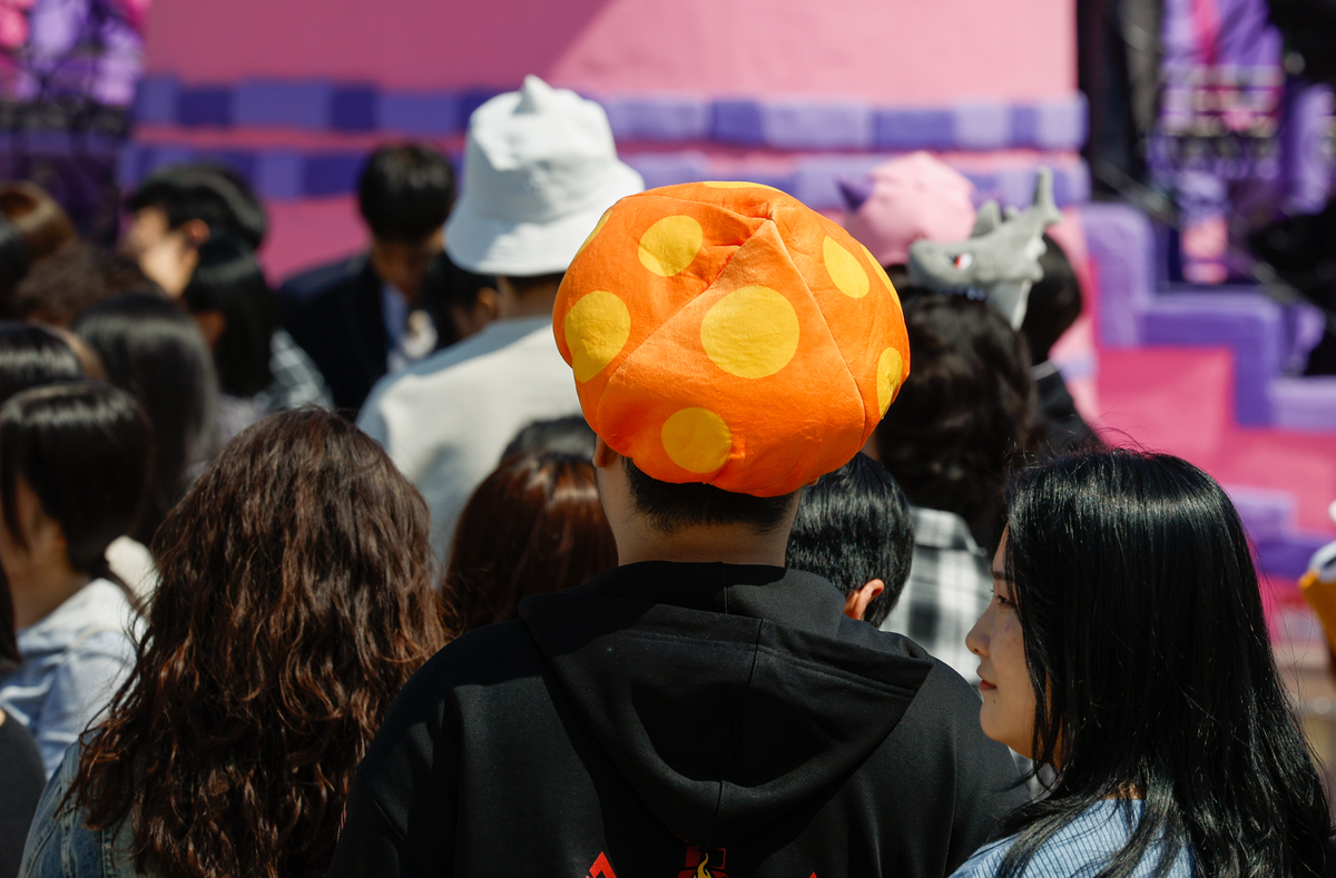 8일 서울 송파구 롯데월드 어드벤처 메이플 아일랜드존에서 게임 캐릭터 모자를 착용한 관람객이 탑승 순서를 기다리고 있다.