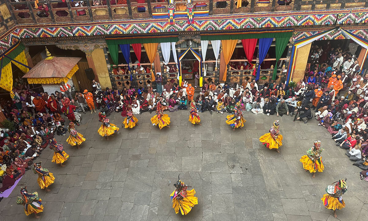 파로 종 안뜰에서 열린 파로 체추 축제. 황금색 치마 의상을 걸치고 가면을 쓴 승려들이 가면무를 공연하고 있다.