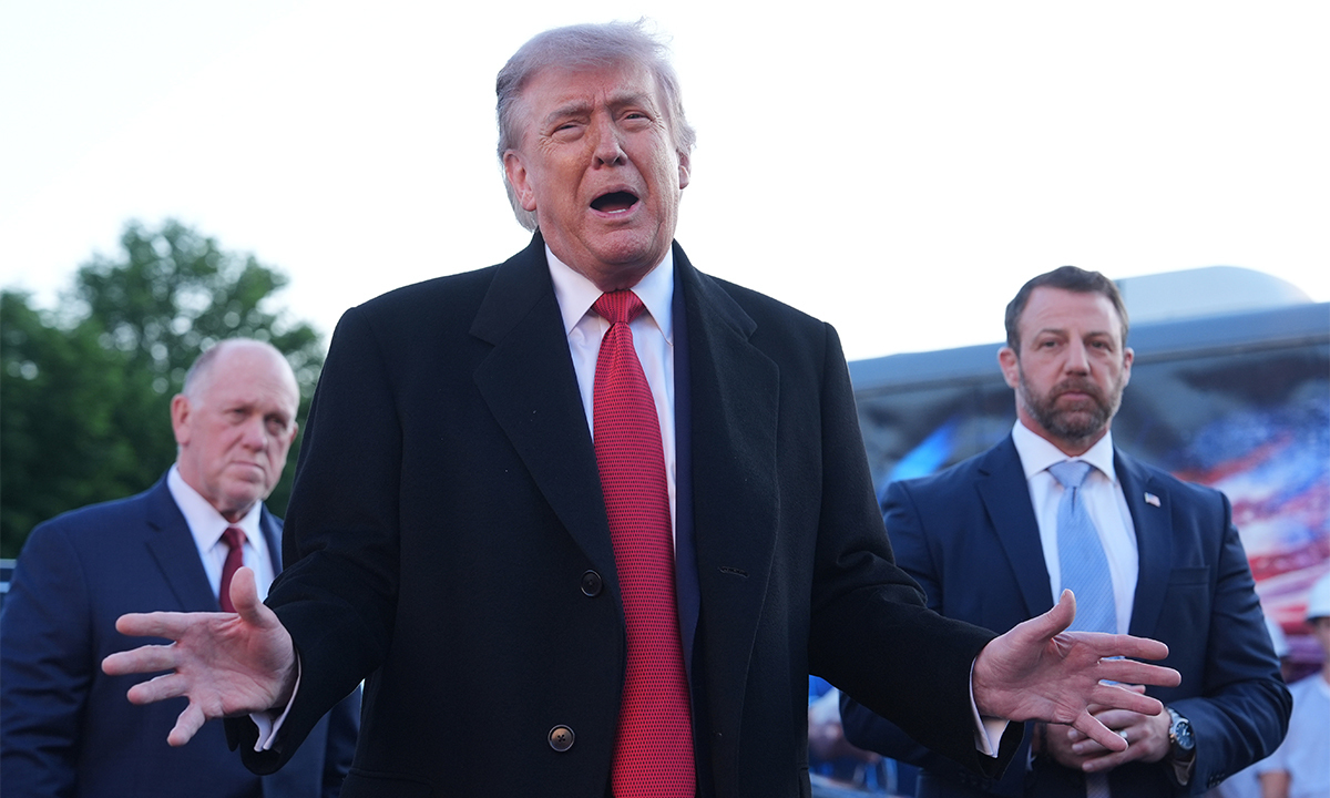 President Donald Trump speaks as he visits the Lincoln Memorial Reflecting Pool to see the new blue protective coating being applied as part of a renovation project, Thursday, May 7, 2026, in Washington. (AP Photo/Mark Schiefelbein)